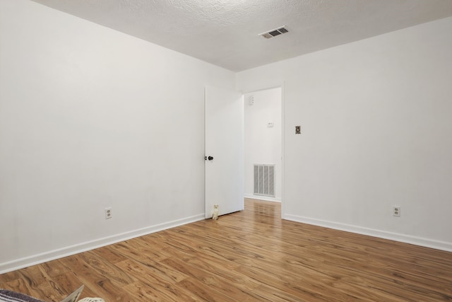3009 Stacy Ln, Deer Park, TX 77536 - empty room featuring light wood-style flooring and a textured ceiling