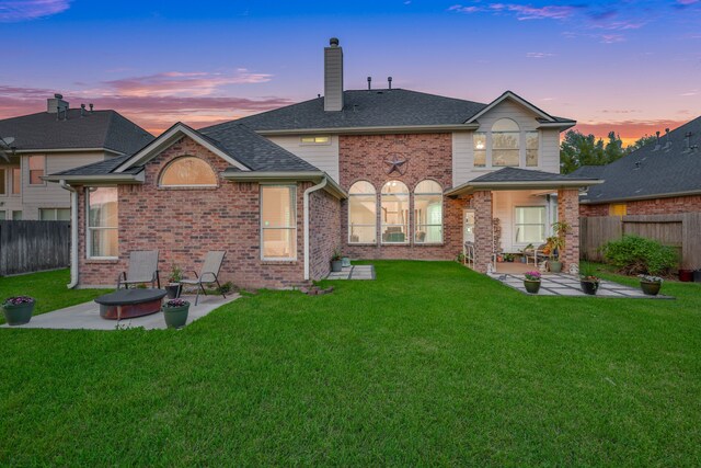 2331 Fern Bend Ln, Katy, TX 77494 - back of house featuring a patio area, brick siding, a fenced backyard, a chimney, and roof with shingles