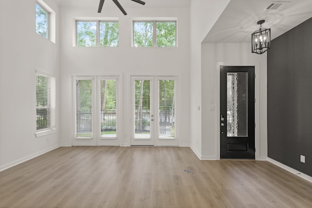 2722 Woodforest Pkwy N, Montgomery, TX 77316 - entrance foyer with ceiling fan, wood finished floors, a high ceiling, and a chandelier