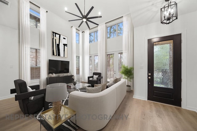 2722 Woodforest Pkwy N, Montgomery, TX 77316 - living room featuring a towering ceiling, wood finished floors, recessed lighting, a chandelier, and a ceiling fan
