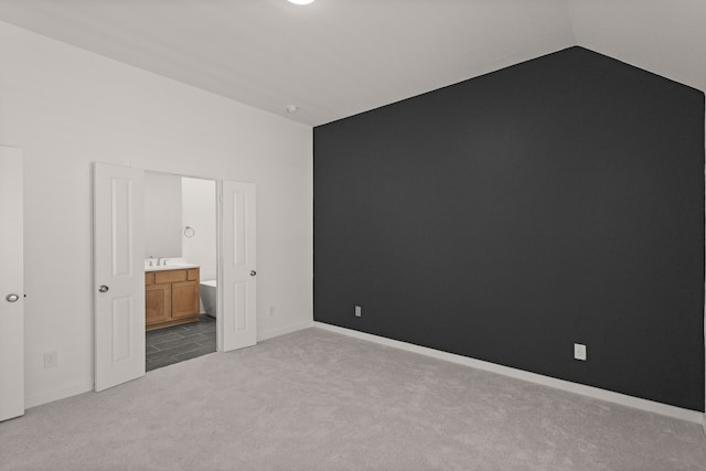 2722 Woodforest Pkwy N, Montgomery, TX 77316 - unfurnished bedroom featuring carpet flooring, lofted ceiling, and connected bathroom