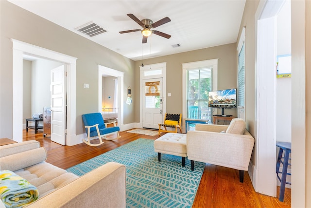 912 Sealy St, Galveston, TX 77550 - living room with wood finished floors, ceiling fan, and baseboard heating