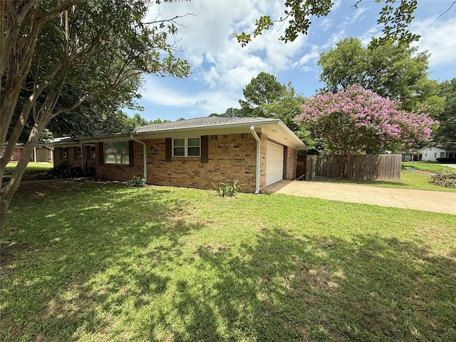 1502 Robin St, Mineola, TX 75773 - view of side of property with driveway, a garage, and brick siding