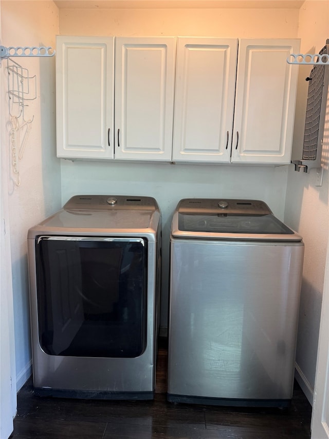 1502 Robin St, Mineola, TX 75773 - washroom featuring cabinet space, washer and dryer, and dark wood-style flooring