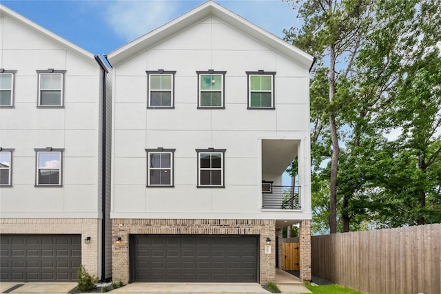 5438A Wheatley St, Houston, TX 77091 - view of property with brick siding, an attached garage, concrete driveway, and stucco siding