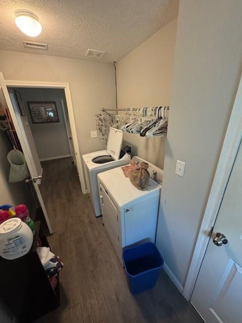 3940 Frontier Rd, Willis, TX 77378 - laundry area with independent washer and dryer, wood finished floors, and a textured ceiling