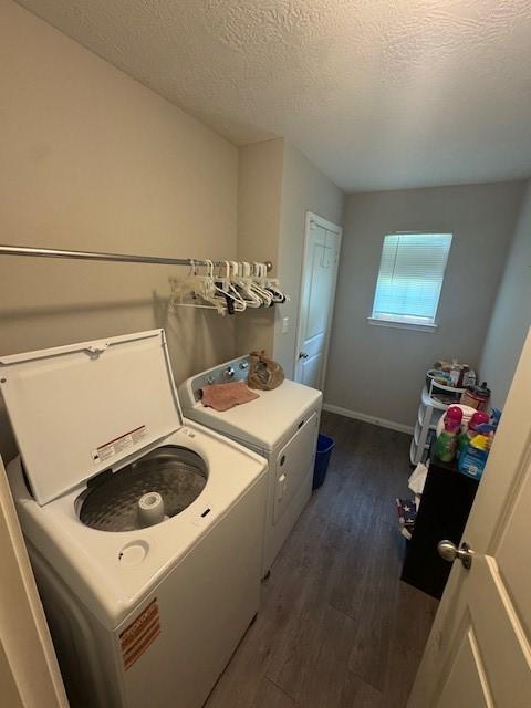 3940 Frontier Rd, Willis, TX 77378 - laundry area featuring dark wood finished floors, a textured ceiling, and washing machine and dryer