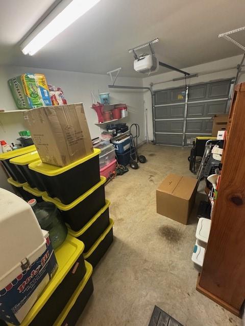 3940 Frontier Rd, Willis, TX 77378 - garage featuring a garage door opener