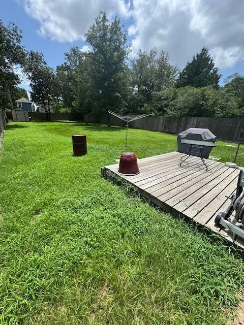 3940 Frontier Rd, Willis, TX 77378 - fenced backyard featuring a wooden deck