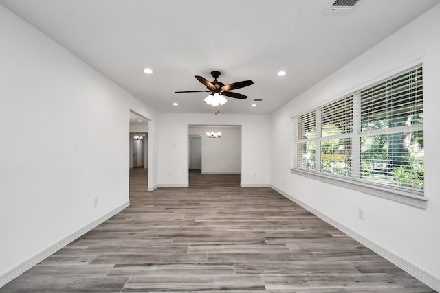 1805 E Ave, Katy, TX 77493 - spare room featuring recessed lighting, ceiling fan, a chandelier, and wood finished floors