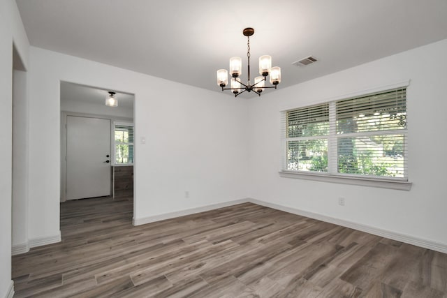 1805 E Ave, Katy, TX 77493 - unfurnished room with a chandelier and wood finished floors