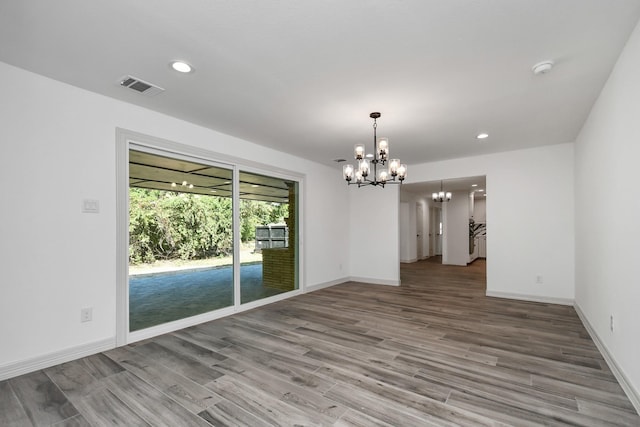 1805 E Ave, Katy, TX 77493 - empty room with a chandelier, wood finished floors, and recessed lighting