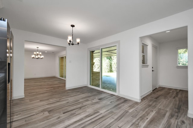 1805 E Ave, Katy, TX 77493 - unfurnished dining area with a chandelier and wood finished floors