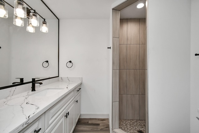 1805 E Ave, Katy, TX 77493 - bathroom with vanity, a tile shower, and wood finished floors