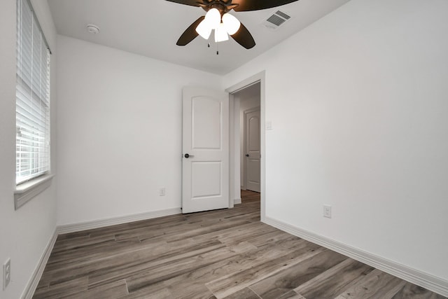 1805 E Ave, Katy, TX 77493 - spare room featuring ceiling fan, wood finished floors, and a smoke detector