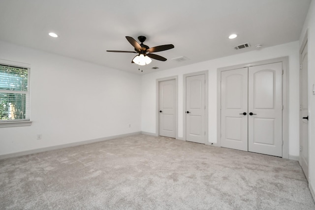 1805 E Ave, Katy, TX 77493 - unfurnished bedroom featuring multiple closets, carpet flooring, recessed lighting, and ceiling fan