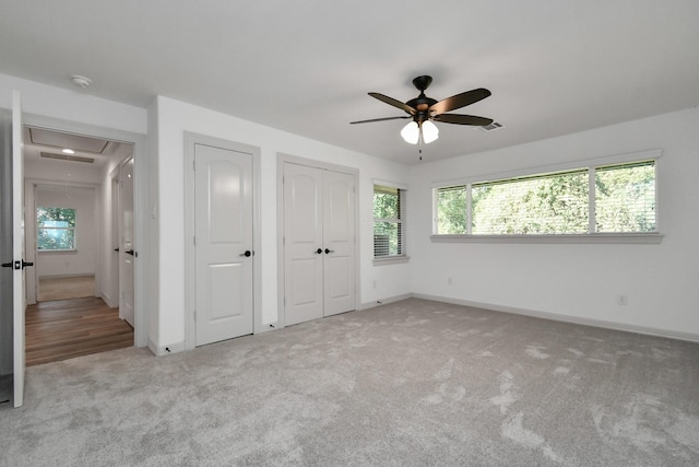1805 E Ave, Katy, TX 77493 - unfurnished bedroom featuring attic access, carpet flooring, multiple windows, and ceiling fan