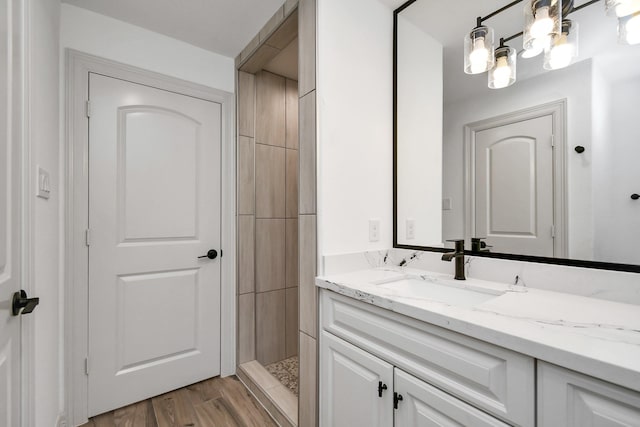 1805 E Ave, Katy, TX 77493 - bathroom with vanity, a tile shower, and wood finished floors