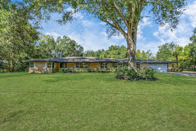 1805 E Ave, Katy, TX 77493 - ranch-style home featuring asphalt driveway, a front lawn, and an attached garage