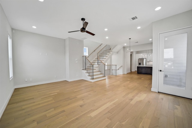 2206 Lou Ellen Ln Unit C, Houston, TX 77018 - unfurnished living room with ceiling fan, stairs, light wood finished floors, healthy amount of natural light, and recessed lighting