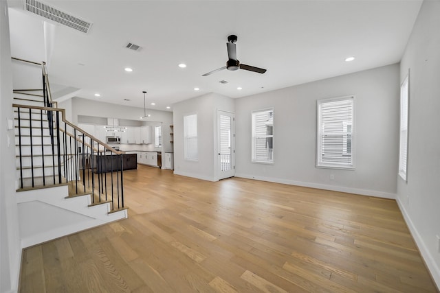 2206 Lou Ellen Ln Unit C, Houston, TX 77018 - living area with a ceiling fan, light wood-style floors, stairway, and recessed lighting