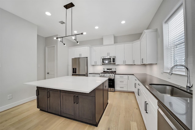 2206 Lou Ellen Ln Unit C, Houston, TX 77018 - kitchen featuring appliances with stainless steel finishes, light wood-type flooring, white cabinetry, and recessed lighting