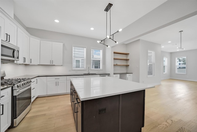 2206 Lou Ellen Ln Unit C, Houston, TX 77018 - kitchen with stainless steel appliances, light wood-style flooring, white cabinetry, a center island, and recessed lighting