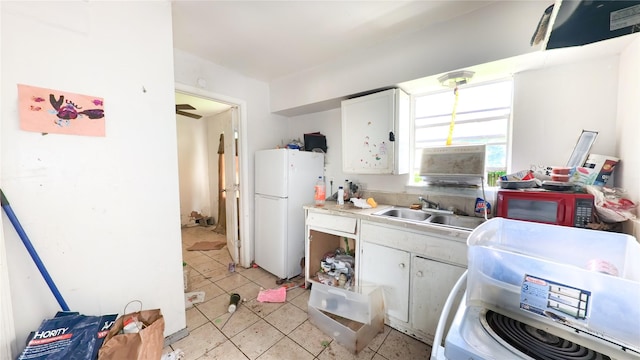 10506 Rosehaven Dr, Houston, TX 77051 - kitchen featuring freestanding refrigerator, white cabinets, light countertops, and light tile patterned flooring
