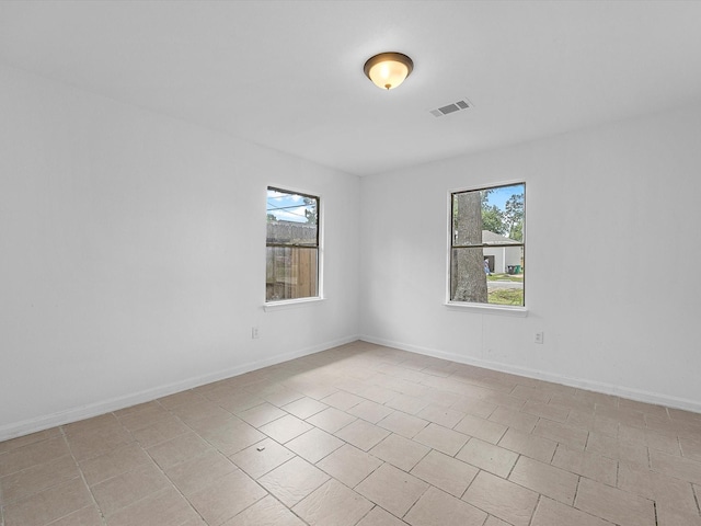 8161 Record St, Houston, TX 77028 - spare room with baseboards and light tile patterned flooring