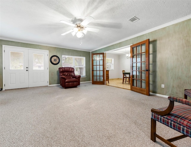 1305 Haines Dr, College Station, TX 77840 - living area featuring french doors, crown molding, ceiling fan, carpet flooring, and a textured ceiling
