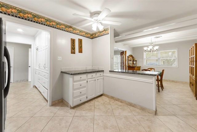 1305 Haines Dr, College Station, TX 77840 - kitchen with light tile patterned flooring, white cabinets, a chandelier, and a ceiling fan