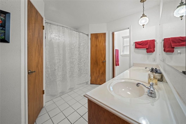23011 Elephant Walk St, Spring, TX 77389 - bathroom with tile patterned floors, double vanity, and curtained shower