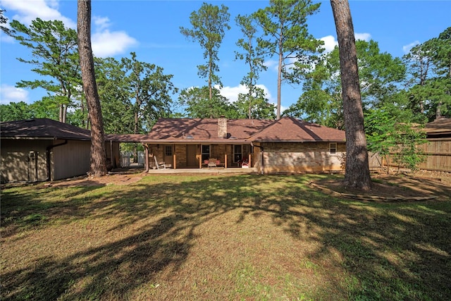 23011 Elephant Walk St, Spring, TX 77389 - back of house featuring a chimney, brick siding, and a patio