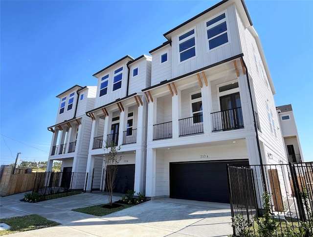 303F Marcella St, Houston, TX 77091 - view of front of home featuring a garage, board and batten siding, and driveway