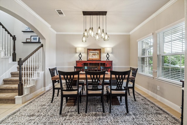 6903 Stevenson Dr, Missouri City, TX 77459 - dining area featuring tile patterned flooring, stairs, crown molding, and arched walkways