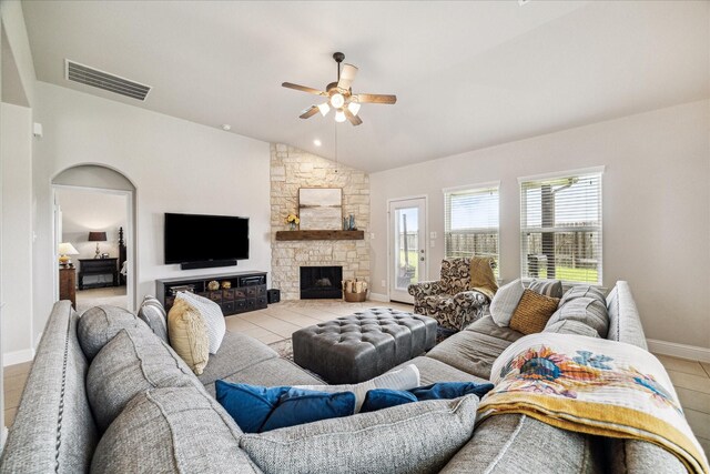 6903 Stevenson Dr, Missouri City, TX 77459 - living room with lofted ceiling, a ceiling fan, tile patterned flooring, and a stone fireplace