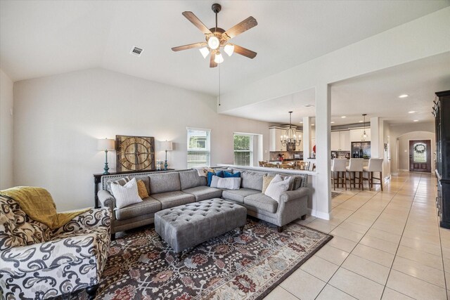 6903 Stevenson Dr, Missouri City, TX 77459 - living room with a ceiling fan, light tile patterned flooring, a chandelier, arched walkways, and lofted ceiling