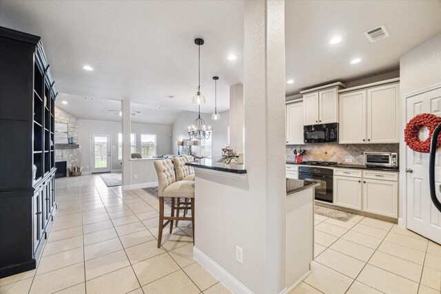6903 Stevenson Dr, Missouri City, TX 77459 - kitchen with black appliances, dark countertops, light tile patterned floors, open floor plan, and tasteful backsplash