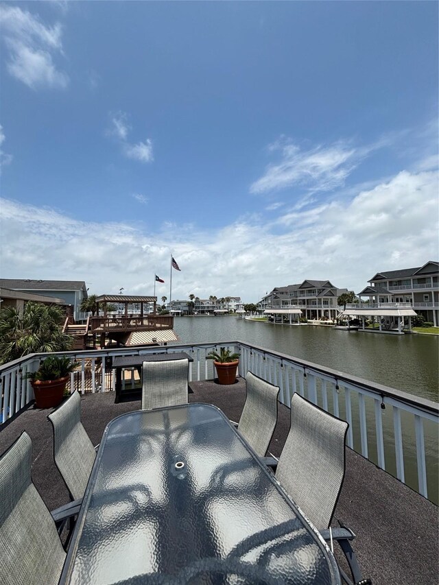3514 Jolly Roger Cir, Galveston, TX 77554 - view of patio with outdoor dining area and a water view