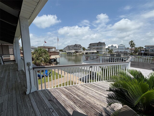 3514 Jolly Roger Cir, Galveston, TX 77554 - wooden deck with a water view, boat lift, a residential view, and a dock