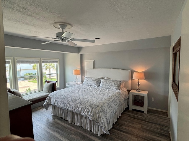 3514 Jolly Roger Cir, Galveston, TX 77554 - bedroom featuring a textured ceiling, dark wood-style floors, and ceiling fan