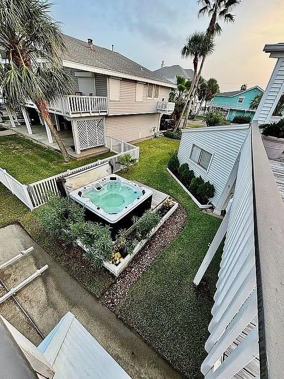 3514 Jolly Roger Cir, Galveston, TX 77554 - view of green lawn with a hot tub