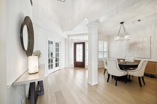 6403 Hidden Crest Way, Sugar Land, TX 77479 - foyer featuring ornate columns, a chandelier, and light wood-style flooring