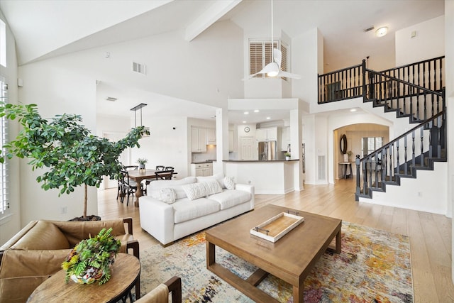 6403 Hidden Crest Way, Sugar Land, TX 77479 - living room with high vaulted ceiling, stairs, light wood finished floors, and beamed ceiling