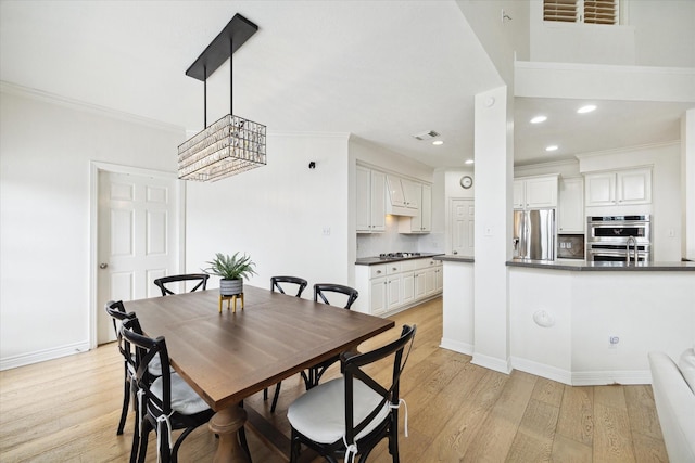6403 Hidden Crest Way, Sugar Land, TX 77479 - dining space with crown molding, light wood-style floors, and recessed lighting