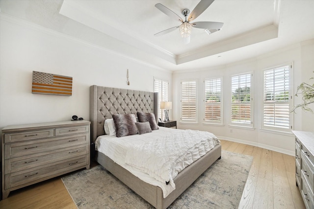 6403 Hidden Crest Way, Sugar Land, TX 77479 - bedroom with a raised ceiling, ornamental molding, light wood-style floors, and a ceiling fan