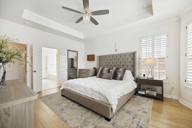 6403 Hidden Crest Way, Sugar Land, TX 77479 - bedroom featuring a tray ceiling, ornamental molding, light wood-style floors, connected bathroom, and a ceiling fan