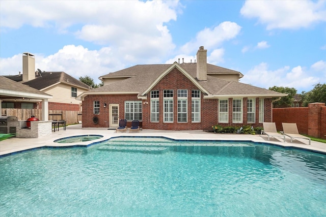 6403 Hidden Crest Way, Sugar Land, TX 77479 - view of swimming pool with an in-ground hot tub, a patio, a fenced backyard, exterior kitchen, and exterior bar