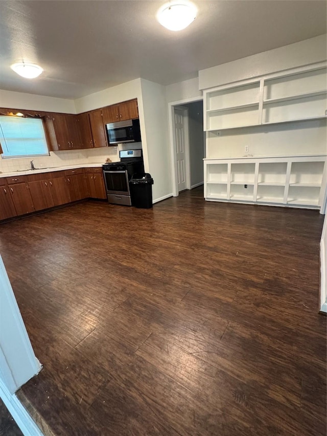 209 W 8th St, Deer Park, TX 77536 - kitchen featuring stainless steel appliances, light countertops, dark wood-style floors, and open shelves