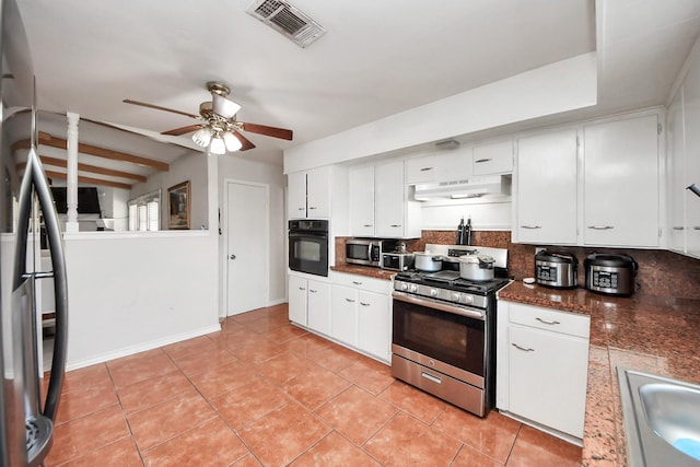 1903 Britton St, Baytown, TX 77520 - kitchen featuring appliances with stainless steel finishes, backsplash, ceiling fan, under cabinet range hood, and dark countertops